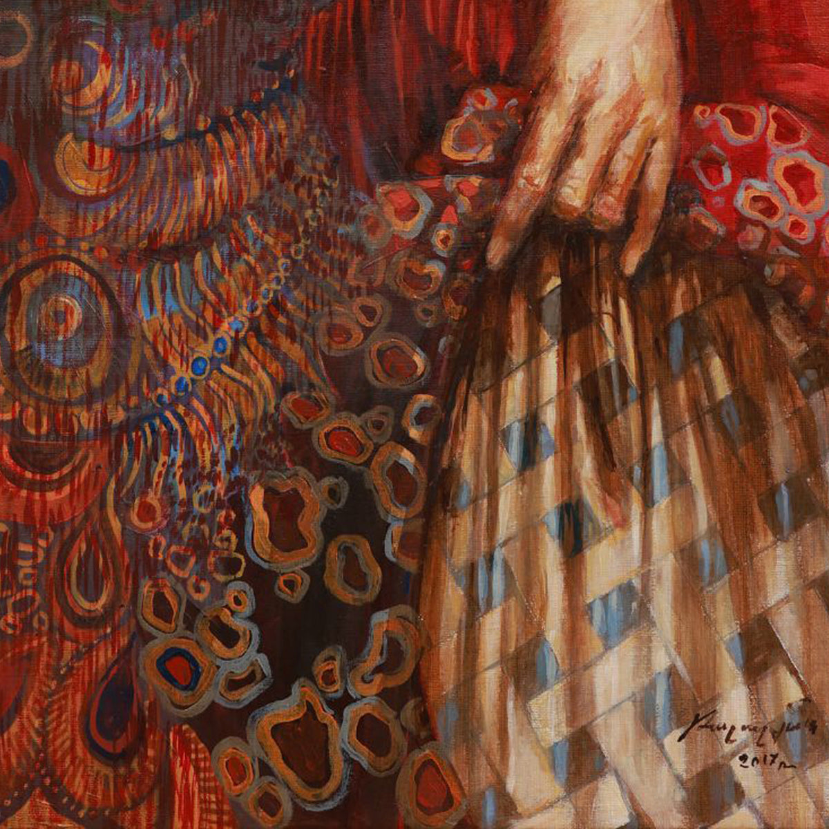 Close-up of a textured fabric with intricate patterns and a hand holding it.