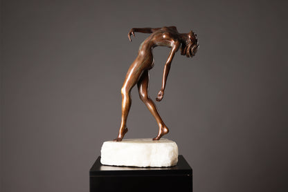 Bronze sculpture of a nude figure on a marble base against a gray background
