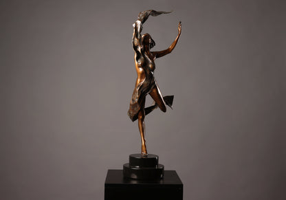 Bronze sculpture of a dancer on a gray background