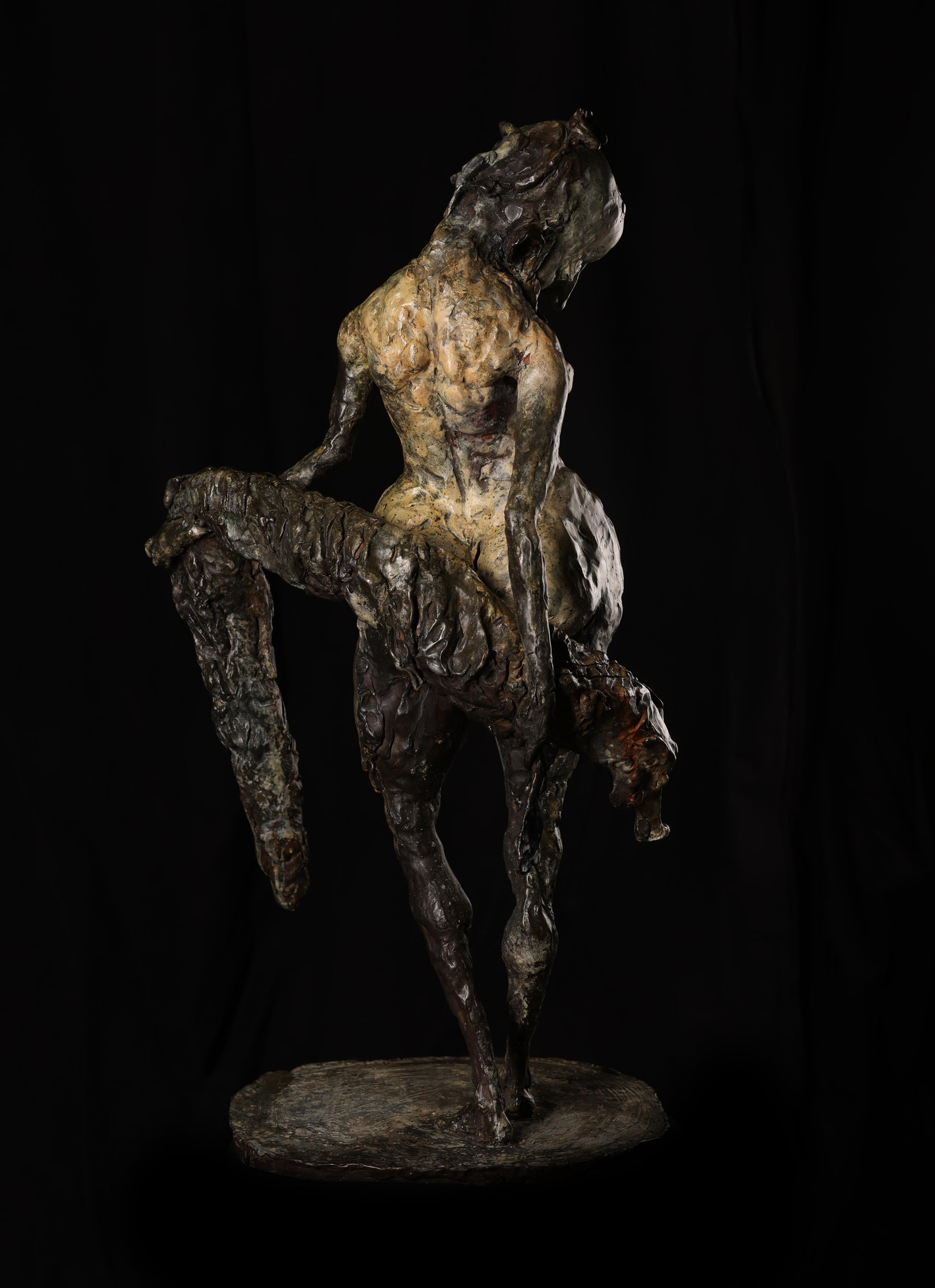 Bronze sculpture of a dancer on a black background