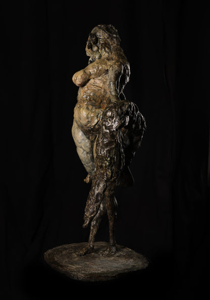 Bronze sculpture of a nude figure with a child on a dark background