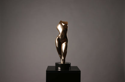 Bronze sculpture of a nude figure on a black pedestal against a gray background
