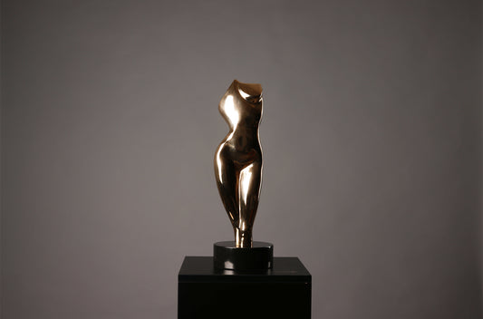 Bronze sculpture of a nude figure on a black pedestal against a gray background