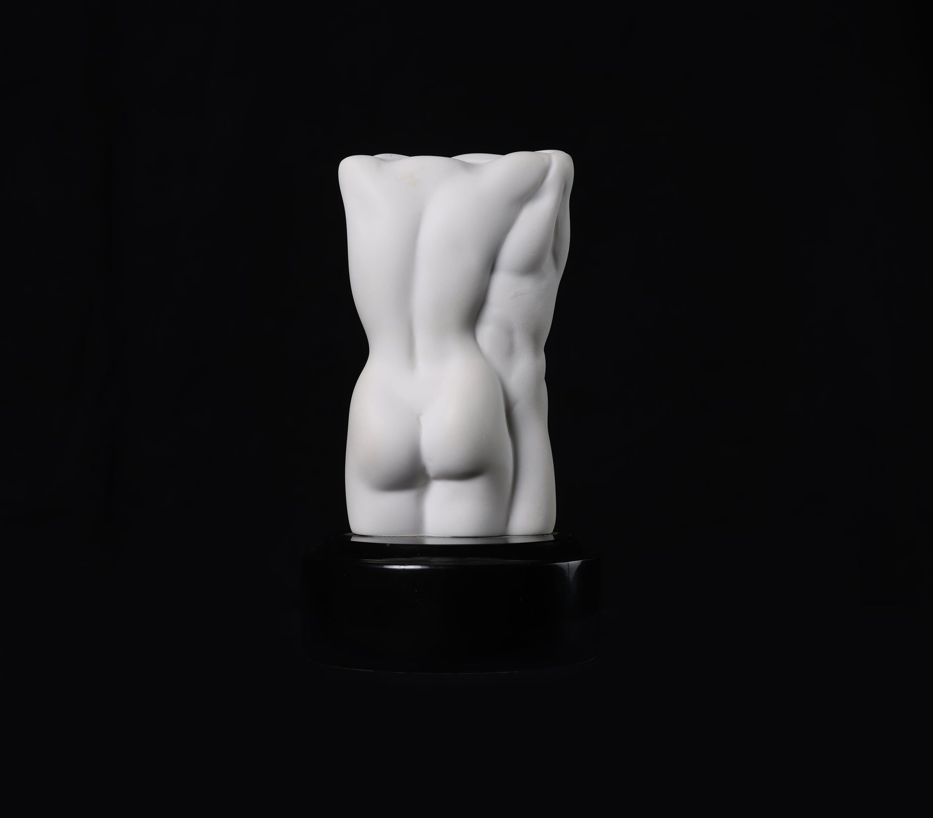 White abstract sculpture on a black background