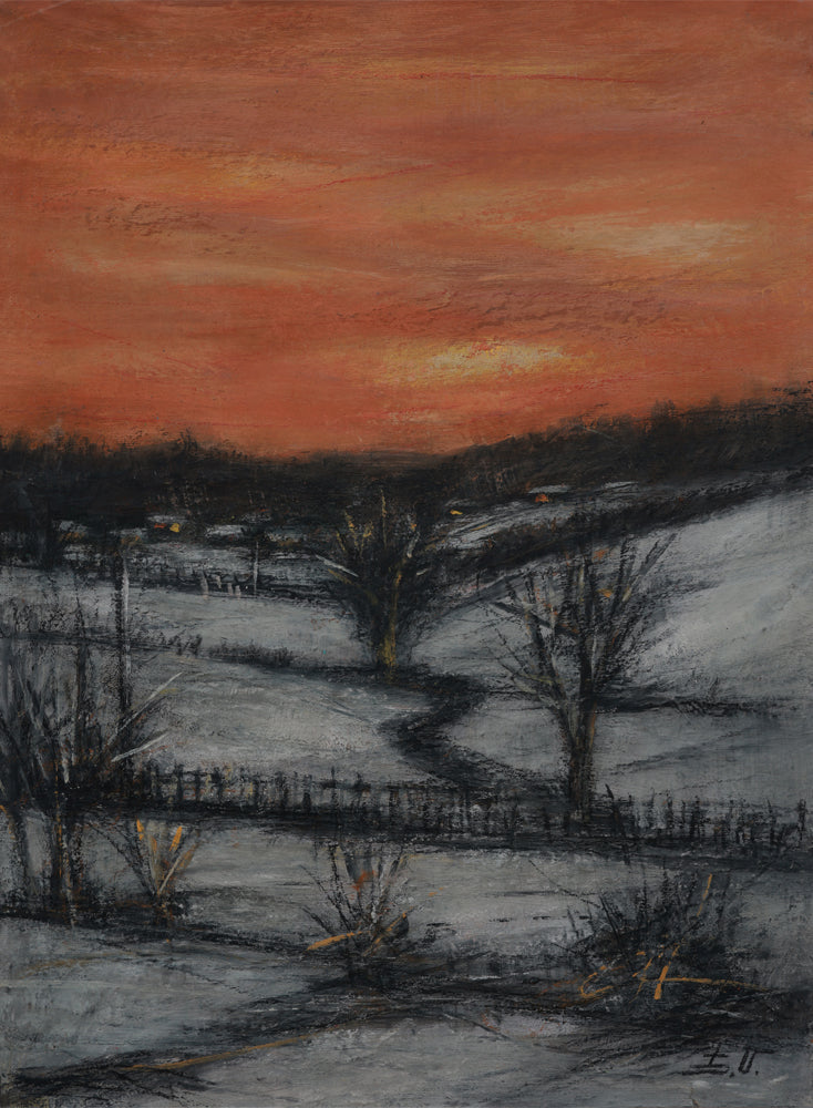 Winter landscape with a sunset sky over snow-covered fields and bare trees.