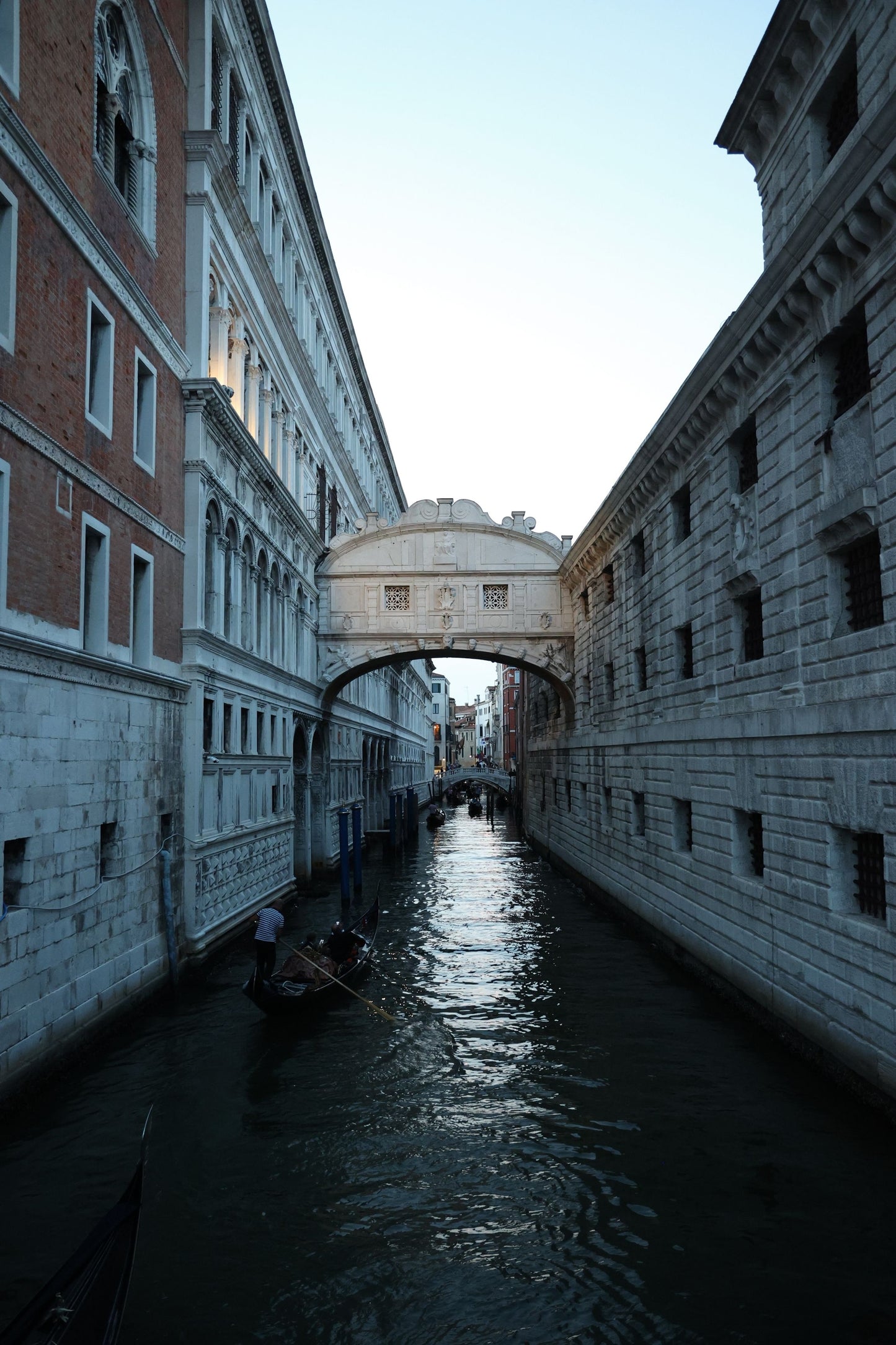 Venetian canal with gondolas and the Bridge of Sighs in the background